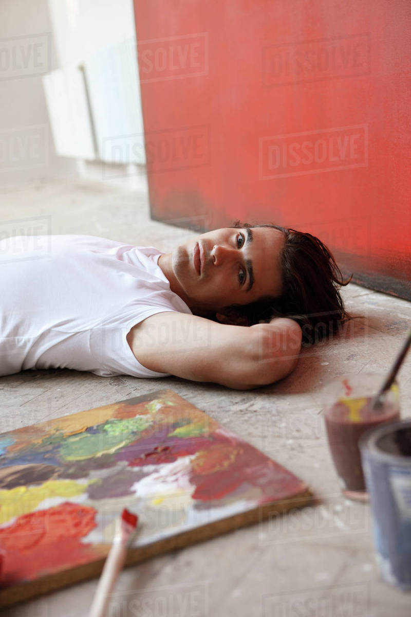 Artist on ground with paints Stock Photo Dissolve