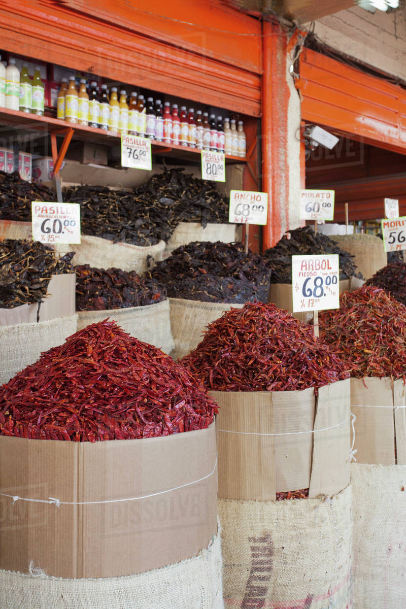 Sacks of various dried chili peppers for sale at an Merced Market