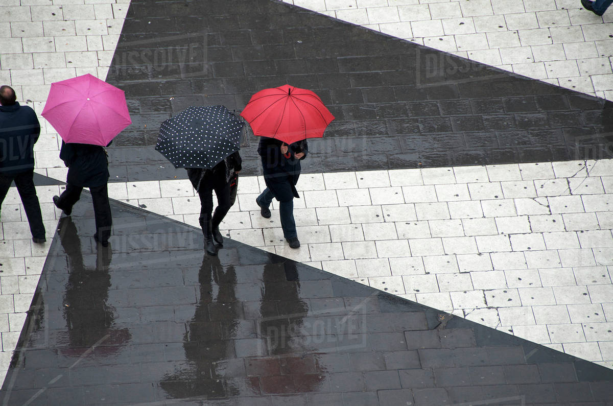Pedestrians below with umbrellas Stock Photo Dissolve