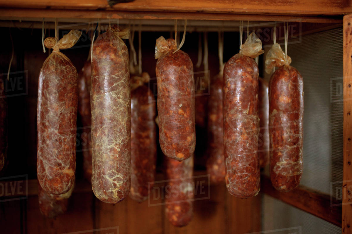 Homemade salami hanging Stock Photo Dissolve