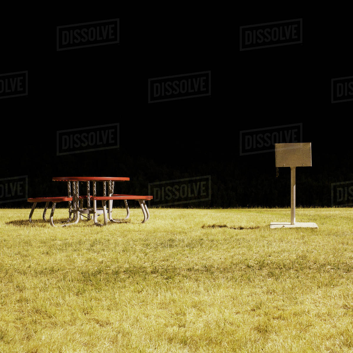 A picnic table and barbecue in a park at night, long exposure Stock
