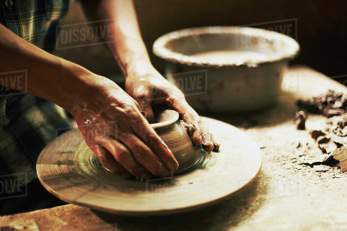 Cropped image of potter moulding clay in Stock Photo Dissolve