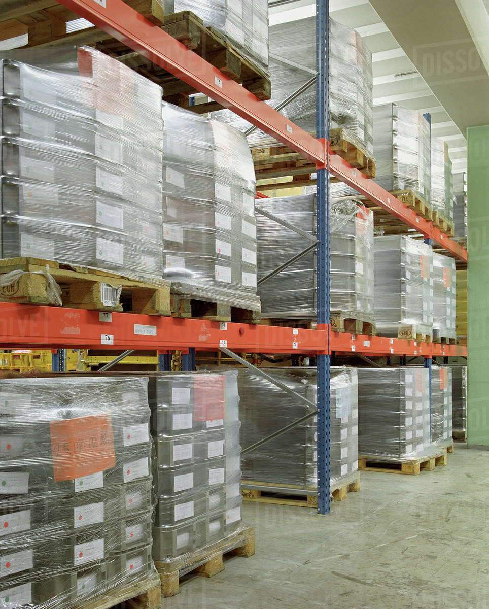 Pallets stacked in a warehouse Stock Photo Dissolve