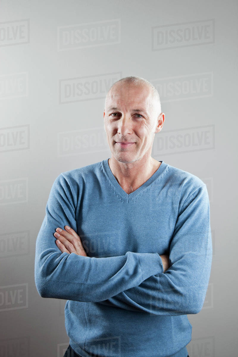 A man with his arms crossed, portrait Stock Photo Dissolve