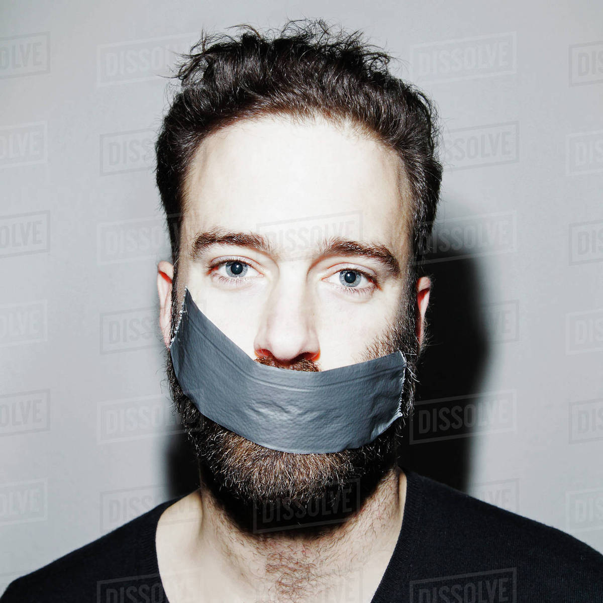 Portrait of man with adhesive tape covering his mouth Stock Photo