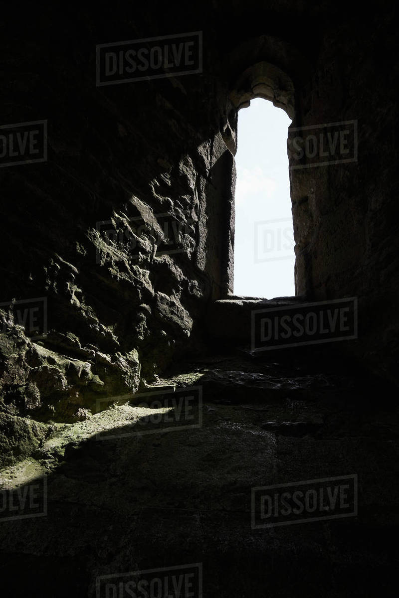 Sunlight streaming through stone arch window, Glastonbury, England Royalty-free stock photo