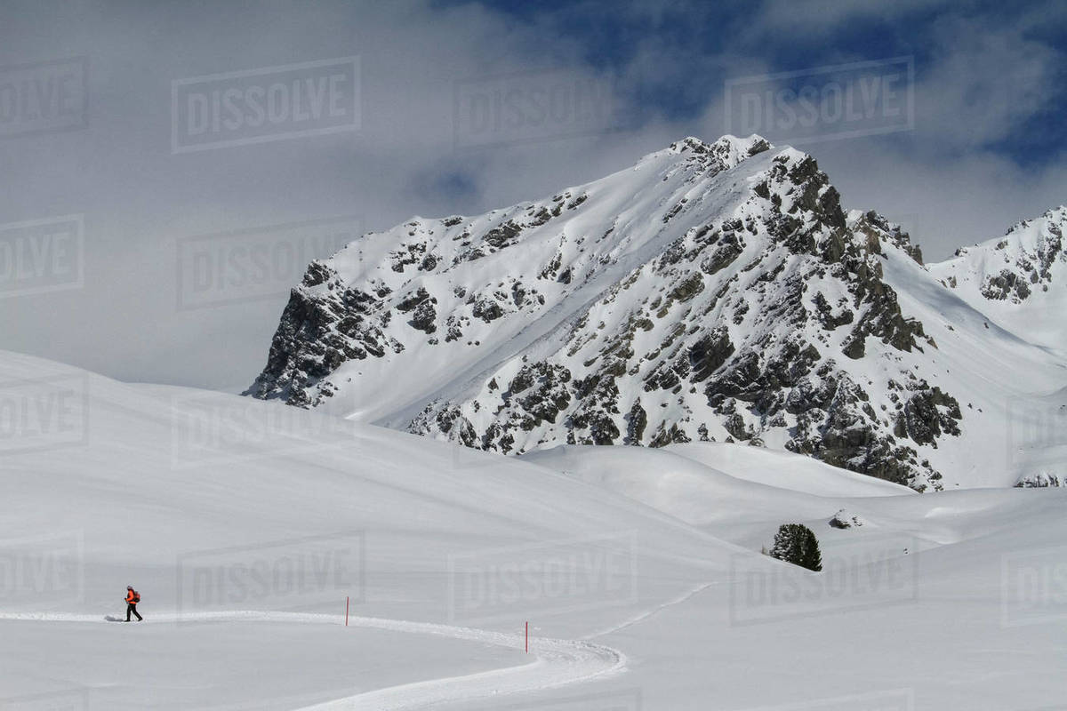 Snowshoer on sunny snowy mountain, Minschuns, Canton of Grisons, Switzerland Royalty-free stock photo