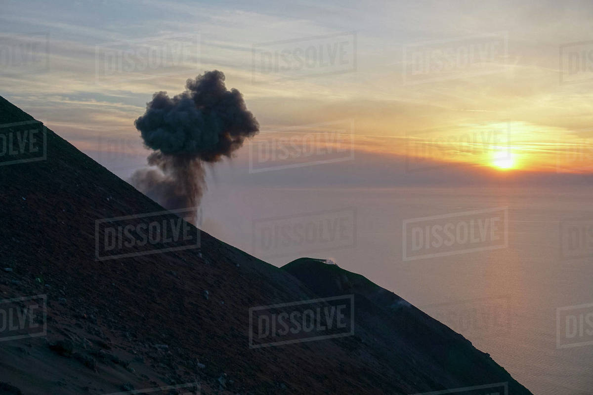 Ash plume rising along tranquil sunset ocean view, Mount Etna, Stromboli, Sicily, Italy Royalty-free stock photo