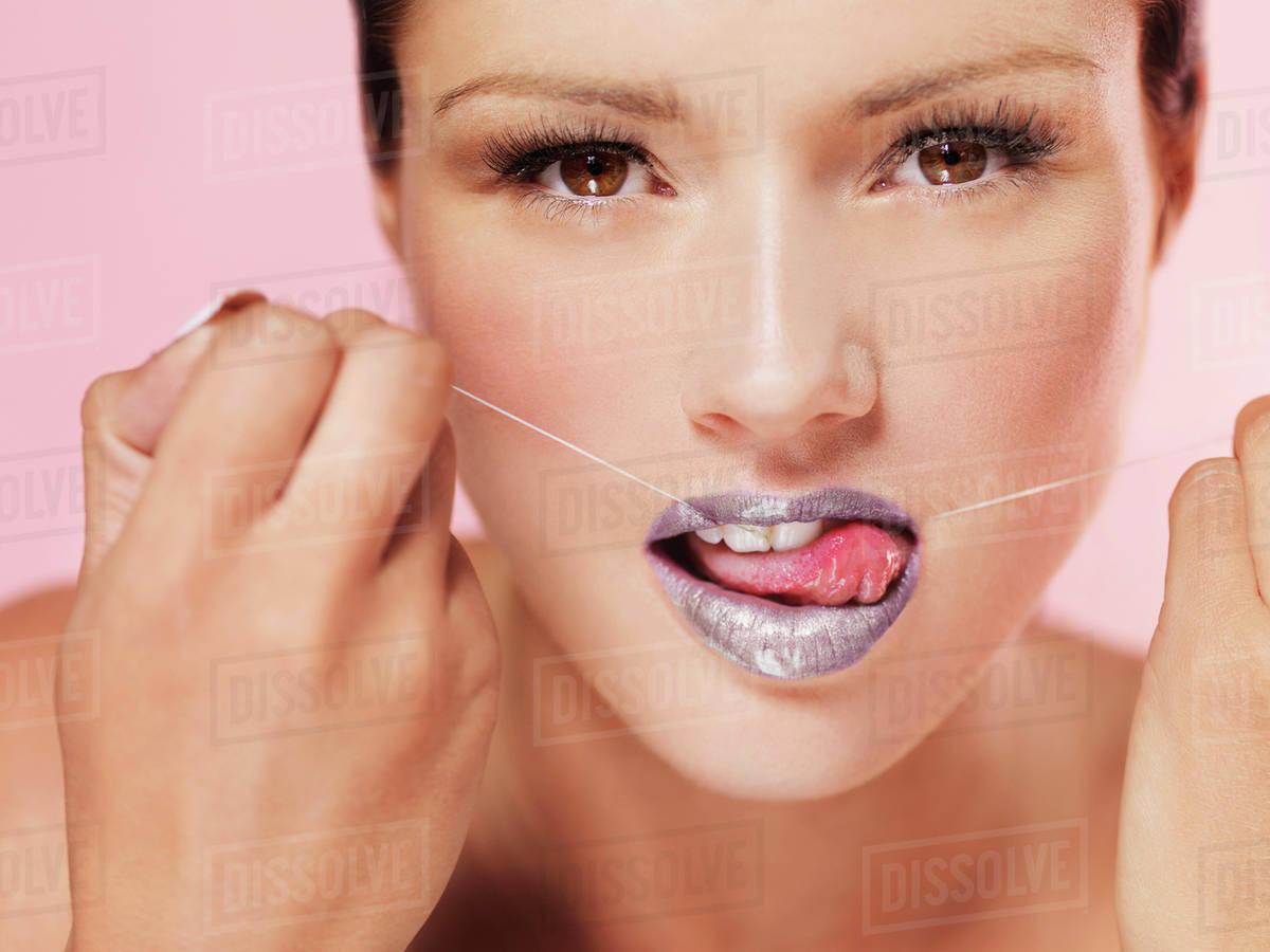 A woman using dental floss suggestively Stock Photo Dissolve